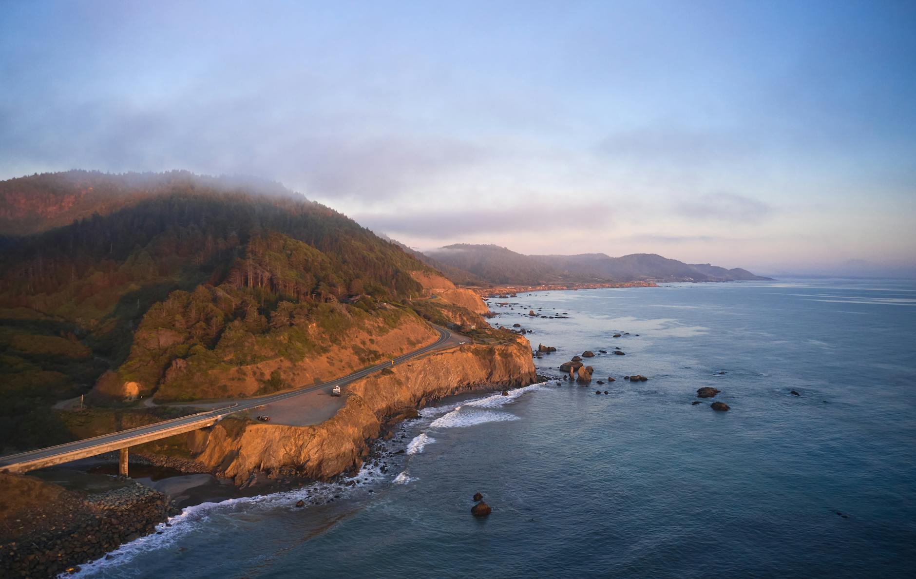 aerial view of sea near brown mountain